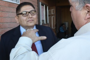 Norwalk City Council candidate Enrique Aranda listens to voter during a recent campaign event.  Randy Economy Photo