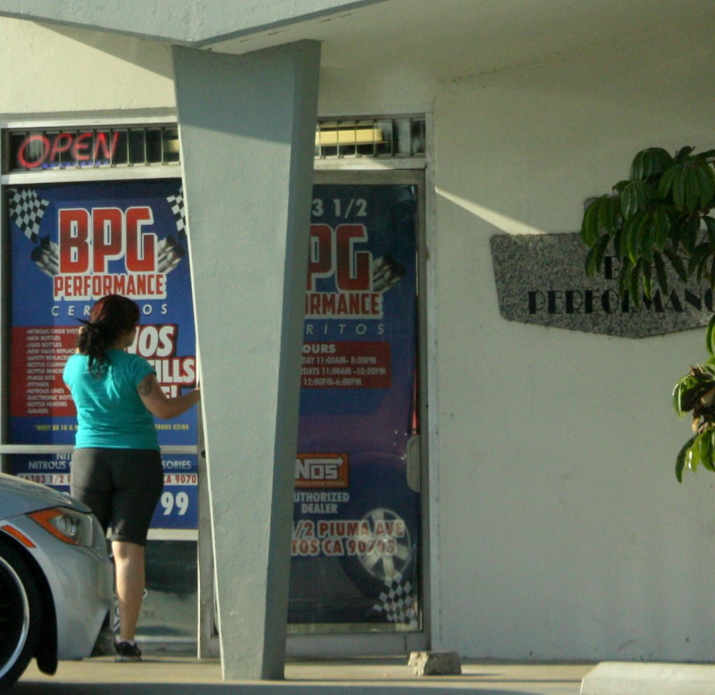 A female attempts to enter BPG in Cerritos on Friday afternoon during a raid on the location for the sales of nitrous oxide.  Randy Economy Photo