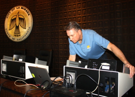 A representative from Martin and Chapman works to try to find glitches in voting tabulation machines. Randy Economy Photo