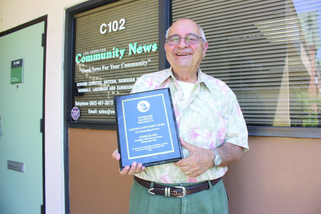 Caption: Charles Ara shows his Lifetime Achievement Award from the Veterans For Peace in front of the Los Cerritos Community Newspaper office this past Wednesday.  Randy Economy Photo