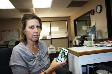 Norwalk resident Sherry Ortiz holds a cell phone photo of her son Daniel Ortiz who was killed in February of this year.